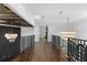 Elegant hallway with dark wood floors and metal railings at 9832 Laurel Valley Dr, Windermere, FL 34786