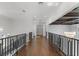 Elegant hallway with hardwood floors and modern metal railings at 9832 Laurel Valley Dr, Windermere, FL 34786