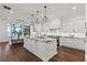 Modern kitchen with white cabinets, large island, and dark hardwood floors at 9832 Laurel Valley Dr, Windermere, FL 34786