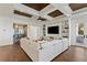 Spacious living room boasts a stunning coffered ceiling, large sectional sofa, and built-in entertainment center at 9832 Laurel Valley Dr, Windermere, FL 34786