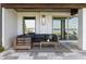 Covered patio with comfortable sectional sofa and lake view at 9832 Laurel Valley Dr, Windermere, FL 34786