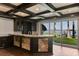 Basement wet bar with marble countertop and lake views at 9832 Laurel Valley Dr, Windermere, FL 34786
