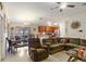 Open living room and kitchen with brown reclining sofa and dining set at 31 Diamond Ridge Way, Ocala, FL 34472