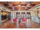 Open concept game room with hardwood floors, bar, and home theatre at 16716 Artimino Loop, Montverde, FL 34756