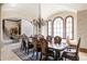 Formal dining room with a large table, chandelier, and views to backyard at 16716 Artimino Loop, Montverde, FL 34756