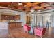 Home bar with wood cabinetry, granite countertop and wine cooler at 16716 Artimino Loop, Montverde, FL 34756