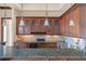 Wet bar with wood cabinets, granite countertops and glass-front cabinets at 16716 Artimino Loop, Montverde, FL 34756