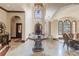 Grand two-story entrance with a large table and chandelier at 16716 Artimino Loop, Montverde, FL 34756