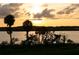 Stunning sunset view over calm lake waters at 16716 Artimino Loop, Montverde, FL 34756