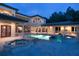 Luxury pool and spa area with outdoor kitchen at 16716 Artimino Loop, Montverde, FL 34756