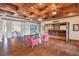 Spacious game room with hardwood floors, coffered ceiling, and home theater at 16716 Artimino Loop, Montverde, FL 34756