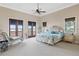 Elegant main bedroom with a plush bed and access to a private balcony at 16716 Artimino Loop, Montverde, FL 34756