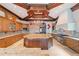 Spacious kitchen with island, wood cabinetry, and granite countertops at 16716 Artimino Loop, Montverde, FL 34756