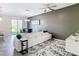 Bright living room with white sofa, gray accent wall, and large windows at 1358 Royal St George Blvd, Davenport, FL 33896