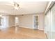 Living room with wood floors, ceiling fan and access to kitchen at 700 Melrose Ave # E4, Winter Park, FL 32789