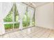 Sunroom with tiled floor, large windows, and white curtains at 700 Melrose Ave # E4, Winter Park, FL 32789
