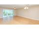 Living room with wood floors and sliding glass doors to patio at 700 Melrose Ave # E4, Winter Park, FL 32789