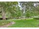 Picturesque pond view with lush greenery and walking path at 700 Melrose Ave # E4, Winter Park, FL 32789