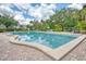 Community pool with brick patio, lounge chairs, and umbrellas at 700 Melrose Ave # E4, Winter Park, FL 32789