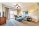 Living room with sofa, chair, and access to balcony at 8125 Resort Village Dr # 5405, Orlando, FL 32821