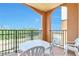 Private balcony with table and chairs, offering wooded views at 8125 Resort Village Dr # 5405, Orlando, FL 32821