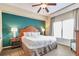 Main bedroom with king bed and teal accent wall at 8125 Resort Village Dr # 5405, Orlando, FL 32821