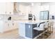 Modern kitchen with white cabinets, center island, and stainless steel appliances at 7904 Waterfield Ave # 1, Orlando, FL 32832