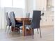 Modern dining room with a wood table and black chairs at 7904 Waterfield Ave # 1, Orlando, FL 32832