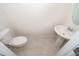 Simple bathroom with pedestal sink and toilet at 2742 Fetching Trl, Davenport, FL 33896