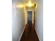 Bright hallway with dark hardwood floors and doors to bedrooms at 225 Se 30Th Ave, Ocala, FL 34471