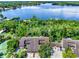 Aerial view showcasing lakefront property and tennis court at 300 N Shadowbay Blvd # 206, Longwood, FL 32779