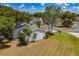 Aerial view of a house with surrounding trees and landscaping at 17775 Se 101St Ct, Summerfield, FL 34491