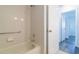 Clean bathroom with a tub and shower, and access to other rooms at 17775 Se 101St Ct, Summerfield, FL 34491
