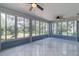 Spacious sunroom with large windows and tile flooring at 17775 Se 101St Ct, Summerfield, FL 34491