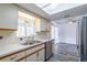 Kitchen with stainless steel dishwasher and view to dining area at 17775 Se 101St Ct, Summerfield, FL 34491