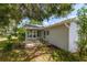 Cozy patio area adjacent to the house, shaded by large trees at 17775 Se 101St Ct, Summerfield, FL 34491