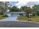 Front view of a single-story house with a two-car garage at 17775 Se 101St Ct, Summerfield, FL 34491