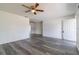 Bright living room featuring gray vinyl plank flooring and a ceiling fan at 17775 Se 101St Ct, Summerfield, FL 34491