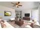 Living room with off-white couches, a wooden coffee table, and a view to the dining area at 17775 Se 101St Ct, Summerfield, FL 34491