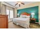 Main bedroom with king bed and teal accent wall at 8125 Resort Village Dr # 5509, Orlando, FL 32821