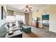 Living room features a sofa, chair, and view into bedroom at 8125 Resort Village Dr # 5509, Orlando, FL 32821