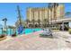 Relaxing pool area with lounge chairs and building view at 8125 Resort Village Dr # 5509, Orlando, FL 32821