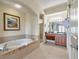 Spa-like bathroom with soaking tub, double vanity, and walk-in shower at 8125 Resort Village Dr # 5509, Orlando, FL 32821