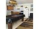 Finished basement with a pool table and kitchenette at 24650 Fox Rd, Astor, FL 32102