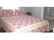 Cozy bedroom with patterned bedding and access to a bathroom at 24650 Fox Rd, Astor, FL 32102