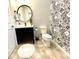Small bathroom with patterned wall and modern vanity at 2178 Cooper Bell Pl, Kissimmee, FL 34747