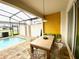 Private screened-in pool area with outdoor dining at 2178 Cooper Bell Pl, Kissimmee, FL 34747