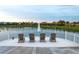 Tranquil lake view with seating area and fountain at 2178 Cooper Bell Pl, Kissimmee, FL 34747