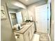 Modern bathroom with vanity and a large mirror at 2178 Cooper Bell Pl, Kissimmee, FL 34747