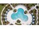 Relaxing resort pool with unique design and plenty of lounge chairs at 2178 Cooper Bell Pl, Kissimmee, FL 34747